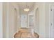Elegant hallway featuring tiled floors, arched doorways, and a classic pendant light fixture at 4210 Vicenza Dr # D25, Venice, FL 34293