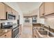 Bright kitchen features stainless appliances and large windows by the breakfast nook at 4210 Vicenza Dr # D25, Venice, FL 34293