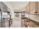 Bright kitchen features stainless appliances and large windows by the breakfast nook at 4210 Vicenza Dr # D25, Venice, FL 34293