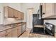 Well-lit kitchen featuring stainless steel appliances and granite countertops at 4210 Vicenza Dr # D25, Venice, FL 34293