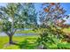 Scenic view from the screened lanai featuring lush greenery and a tranquil lake at 4210 Vicenza Dr # D25, Venice, FL 34293