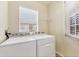 Functional laundry room with a washer, dryer, and a window allowing natural light at 4210 Vicenza Dr # D25, Venice, FL 34293