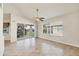 Bright living room featuring tile floors, ceiling fan, access to the balcony, and large windows at 4210 Vicenza Dr # D25, Venice, FL 34293