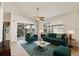 Living room with tiled floors, high ceilings, comfortable furniture, and access to the balcony at 4210 Vicenza Dr # D25, Venice, FL 34293