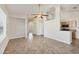 Open-concept living room with tile flooring, a ceiling fan, and a view of the kitchen at 4210 Vicenza Dr # D25, Venice, FL 34293