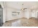 Spacious living room with tiled floors, neutral paint, and fan at 4210 Vicenza Dr # D25, Venice, FL 34293
