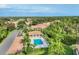 Aerial view of a cabana, pool, lounge chairs and palm trees in a picturesque community at 4210 Vicenza Dr # D25, Venice, FL 34293