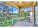Relaxing screened lanai with a ceiling fan and views of a serene lake and lush landscape at 4210 Vicenza Dr # D25, Venice, FL 34293