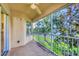 Inviting screened lanai with a ceiling fan and scenic views of the surrounding lake and landscape at 4210 Vicenza Dr # D25, Venice, FL 34293