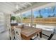 Cozy screened-in back porch with wood table and chairs, perfect for enjoying the outdoors at 4214 Groveland Ave, Sarasota, FL 34231