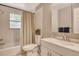 This bathroom features a shower and tub combination, with a vanity offering a clean and functional space at 4214 Groveland Ave, Sarasota, FL 34231
