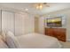 Bright bedroom featuring a large closet, window with blinds, dresser with TV for relaxing evenings at 4214 Groveland Ave, Sarasota, FL 34231