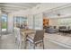 Open dining area with seating for six, seamlessly connecting to the living room with access to the backyard at 4214 Groveland Ave, Sarasota, FL 34231