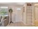Entryway with tiled floors, open shelving and coat rack stand by front door at 4214 Groveland Ave, Sarasota, FL 34231