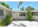 Close-up of the front entrance with white door, plants, and rock landscaping at 4214 Groveland Ave, Sarasota, FL 34231