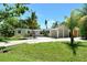 Inviting single-story home featuring lush landscaping, driveway and carport at 4214 Groveland Ave, Sarasota, FL 34231
