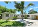 Attractive one-story home with vibrant plants, rock landscaping, and a carport at 4214 Groveland Ave, Sarasota, FL 34231