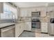 Bright kitchen featuring stainless steel appliances, granite countertops, and modern cabinetry at 4214 Groveland Ave, Sarasota, FL 34231