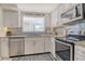 Modern kitchen featuring stainless steel appliances, granite countertops, and ample cabinet space at 4214 Groveland Ave, Sarasota, FL 34231