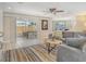 Bright living room with tile floors, neutral decor, and view into dining area at 4214 Groveland Ave, Sarasota, FL 34231