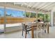 Covered back patio with dining set overlooking a backyard at 4214 Groveland Ave, Sarasota, FL 34231