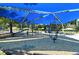 Covered playground featuring climbing structures, swings, and slides with shade for enjoyable outdoor play at 4214 Groveland Ave, Sarasota, FL 34231