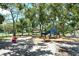 A colorful playground under the shade of mature trees, perfect for Gathering fun and outdoor activities at 4214 Groveland Ave, Sarasota, FL 34231