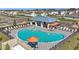 Stunning aerial view of the community pool featuring ample seating, a covered pavilion, and pristine landscaping at 4336 112Th E St, Palmetto, FL 34221
