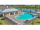 Beautiful community pool area with lounge chairs, umbrellas, and a covered pavilion, perfect for relaxing and socializing at 4336 112Th E St, Palmetto, FL 34221