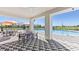 Inviting community pool area with outdoor seating under a covered patio, creating an ideal spot for relaxation and recreation at 4336 112Th E St, Palmetto, FL 34221