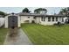 Spacious backyard with a shed, lush green lawn, and a concrete walkway, perfect for outdoor living at 4337 15Th N Ave, St Petersburg, FL 33713