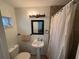 Cozy bathroom with a pedestal sink, toilet, shower with curtain, and modern lighting at 4337 15Th N Ave, St Petersburg, FL 33713