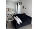 Bedroom featuring a comfortable bed, a stylish sofa, and modern decor at 4337 15Th N Ave, St Petersburg, FL 33713