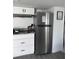 Modern kitchen featuring white cabinets, stainless steel refrigerator, and granite countertops at 4337 15Th N Ave, St Petersburg, FL 33713