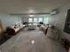 Open living room featuring custom seating around a center table with backyard views at 4337 15Th N Ave, St Petersburg, FL 33713