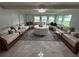 Open living room featuring custom seating around a center table with backyard views at 4337 15Th N Ave, St Petersburg, FL 33713