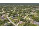 A picturesque aerial view showcases a quiet neighborhood with lush, green trees at 4357 Mermell Cir, North Port, FL 34291