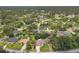 An aerial view of a quiet residential neighborhood with lush landscaping and mature trees at 4357 Mermell Cir, North Port, FL 34291