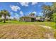 The spacious backyard featuring an enclosed porch, a trailer, and mature landscaping at 4357 Mermell Cir, North Port, FL 34291