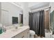 Bathroom featuring a vanity sink, toilet, and shower with curtain at 4357 Mermell Cir, North Port, FL 34291