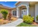 Inviting front entry, featuring decorative columns and attractive landscaping at 4357 Mermell Cir, North Port, FL 34291