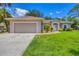 Attractive home with a large lawn, spacious driveway, and beautiful, verdant landscaping at 4357 Mermell Cir, North Port, FL 34291
