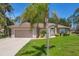 A well-manicured front lawn enhances this cozy home's curb appeal with inviting driveway at 4357 Mermell Cir, North Port, FL 34291