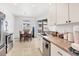Eat-in kitchen with stainless appliances, tile flooring and sliding door access to patio area at 4357 Mermell Cir, North Port, FL 34291