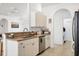 Bright kitchen features tile flooring, a dishwasher, and ample cabinets for storage at 4357 Mermell Cir, North Port, FL 34291