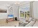 Inviting living room showcases natural light from a large window, tile flooring, and comfortable seating at 4357 Mermell Cir, North Port, FL 34291