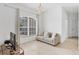 Cozy living room featuring neutral paint, tile flooring, and a comfortable couch near a bright window at 4357 Mermell Cir, North Port, FL 34291