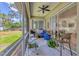 Covered screened patio with fan and outdoor seating at 4357 Mermell Cir, North Port, FL 34291