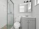 Modern bathroom features a glass shower, gray vanity, and white subway tile at 4507 9Th W St # J11, Bradenton, FL 34207