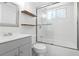 Bright bathroom featuring subway tiles, floating shelves, and a glass shower enclosure at 4507 9Th W St # J11, Bradenton, FL 34207